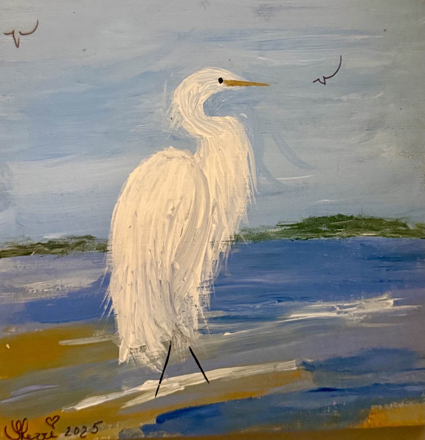 White egret standing at the edge of blue water