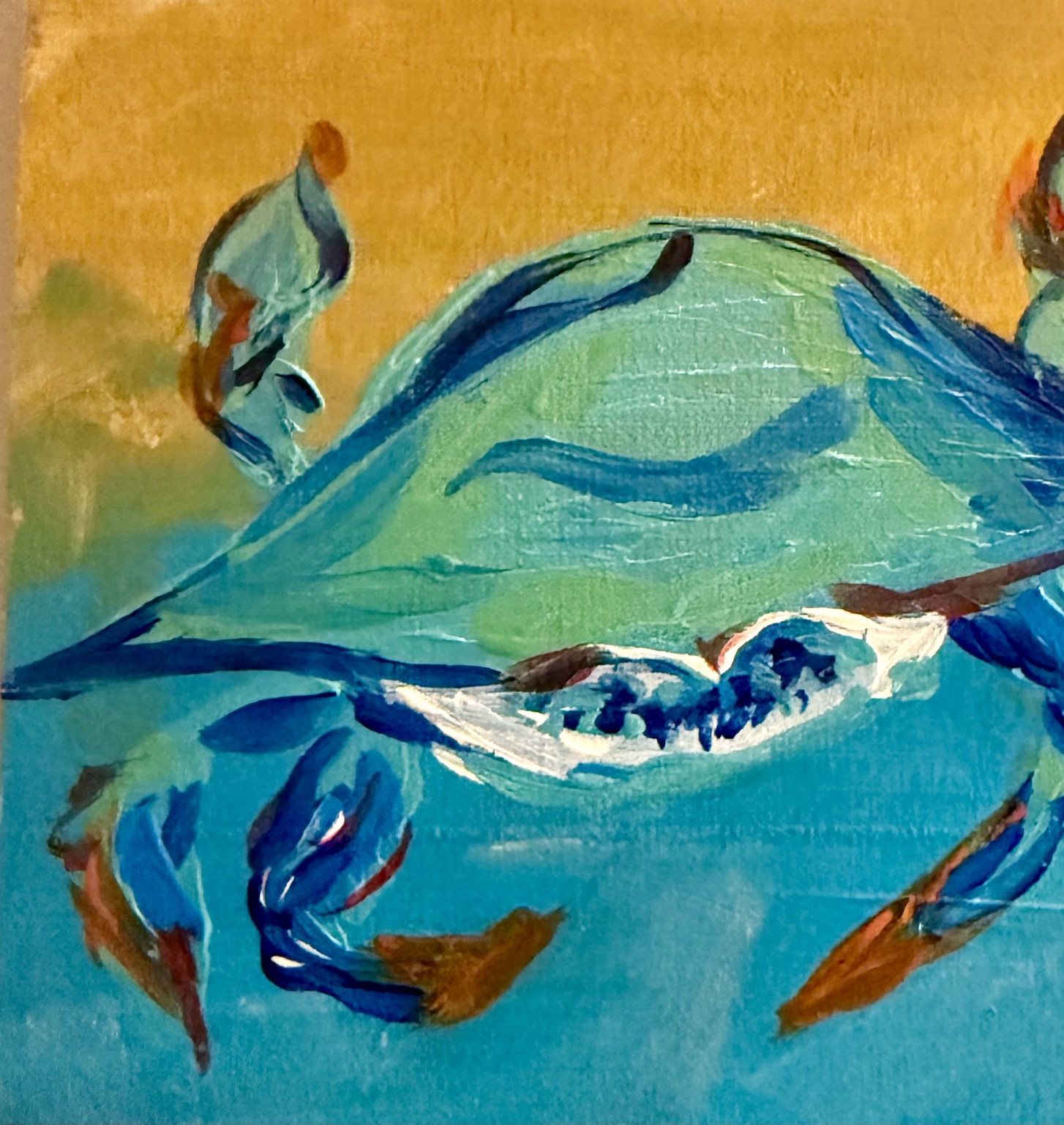 Blue crab painted against a warm yellow and turquoise background