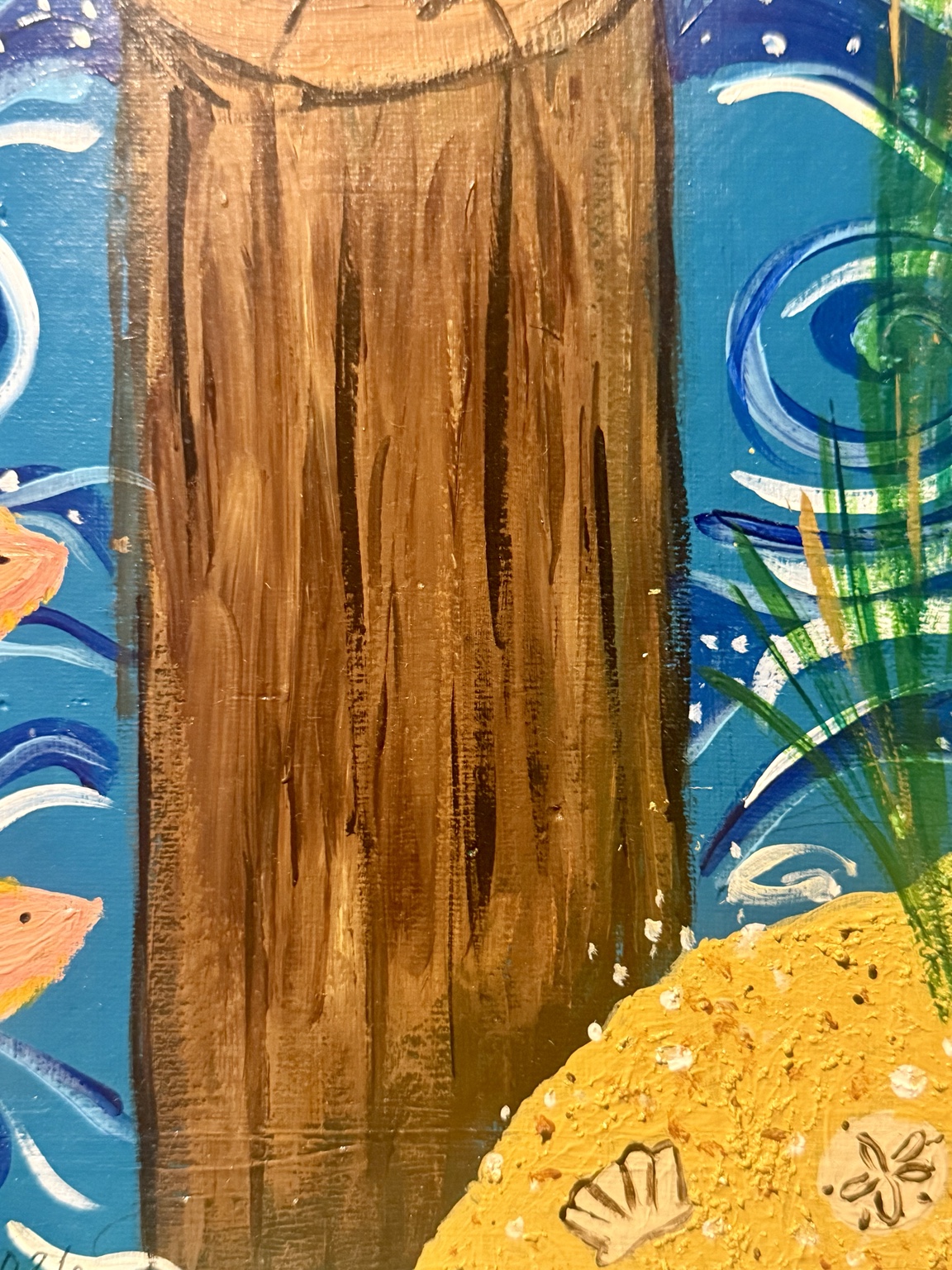 Close-up of the piling, beach, and waves