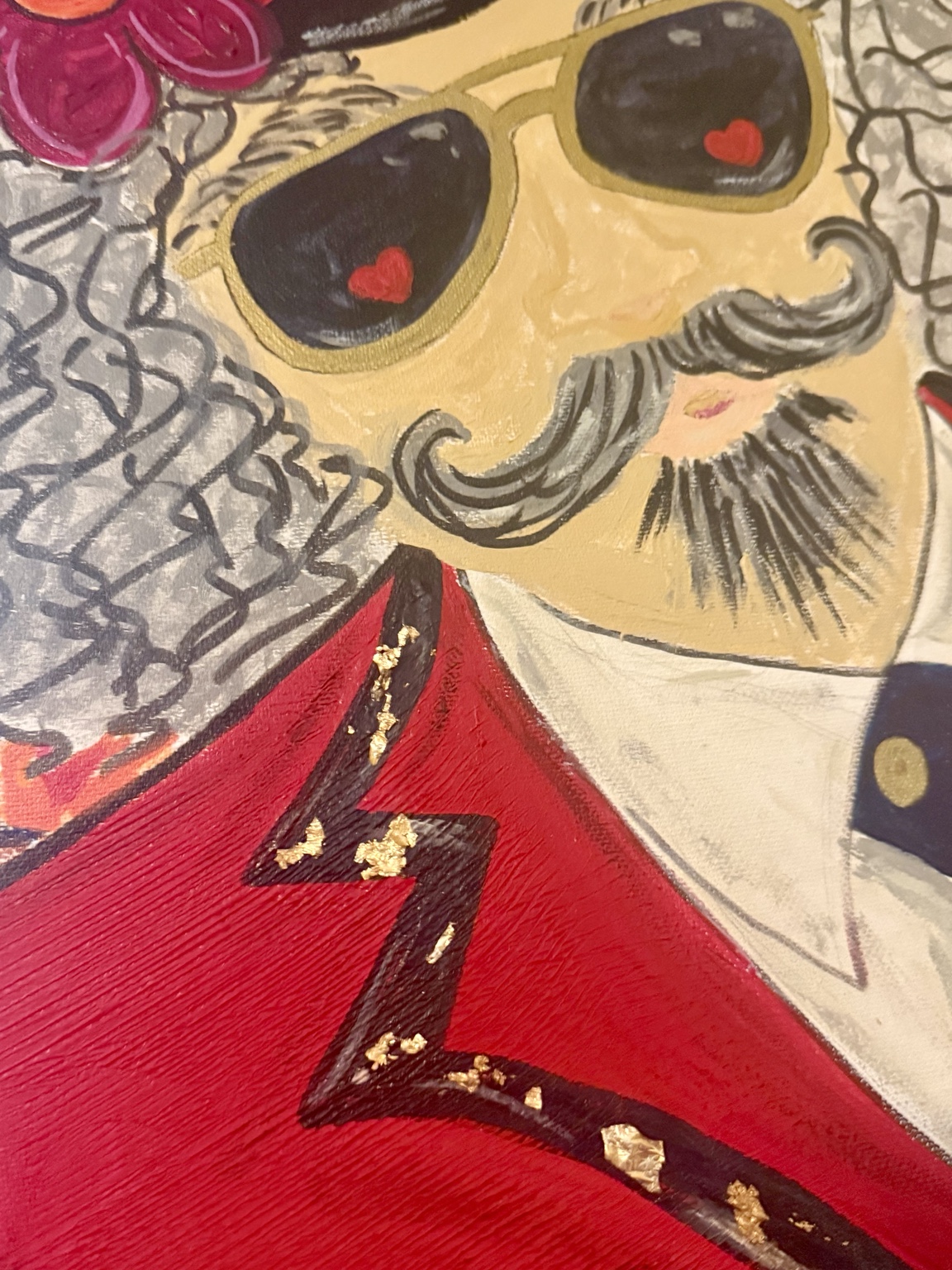 Close-up of the ringmaster's sunglasses, mustache, and red jacket