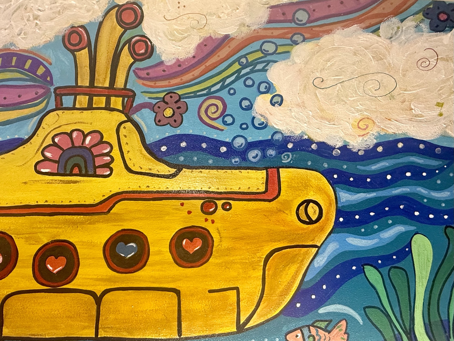 Close-up of the submarine's heart-shaped portholes and colorful sky