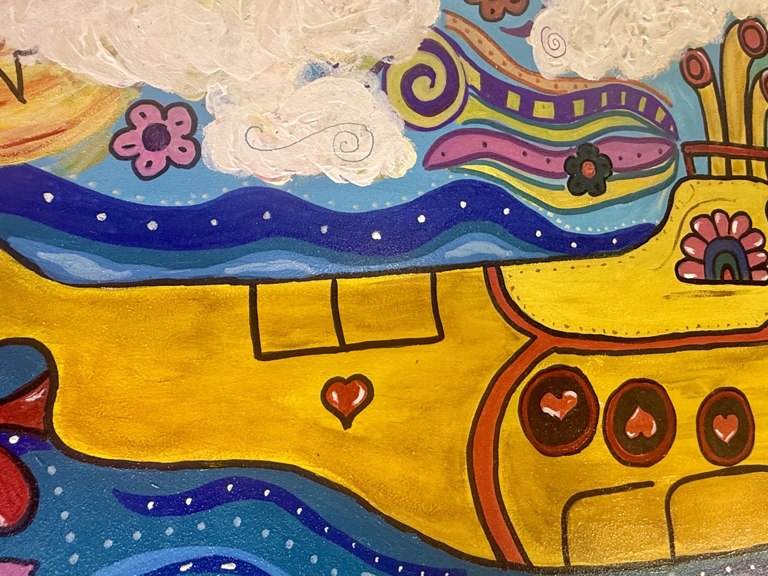 Close-up of the yellow hull, heart, and blue waves