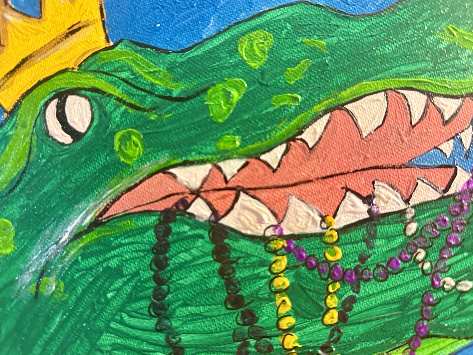 Close-up of alligator's face and Mardi Gras beads