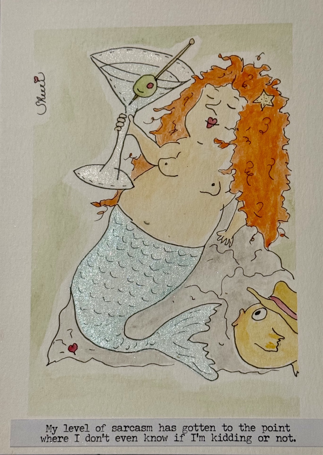 Mabel the red-haired mermaid raises a sparkling martini beside a playful hand-lettered caption