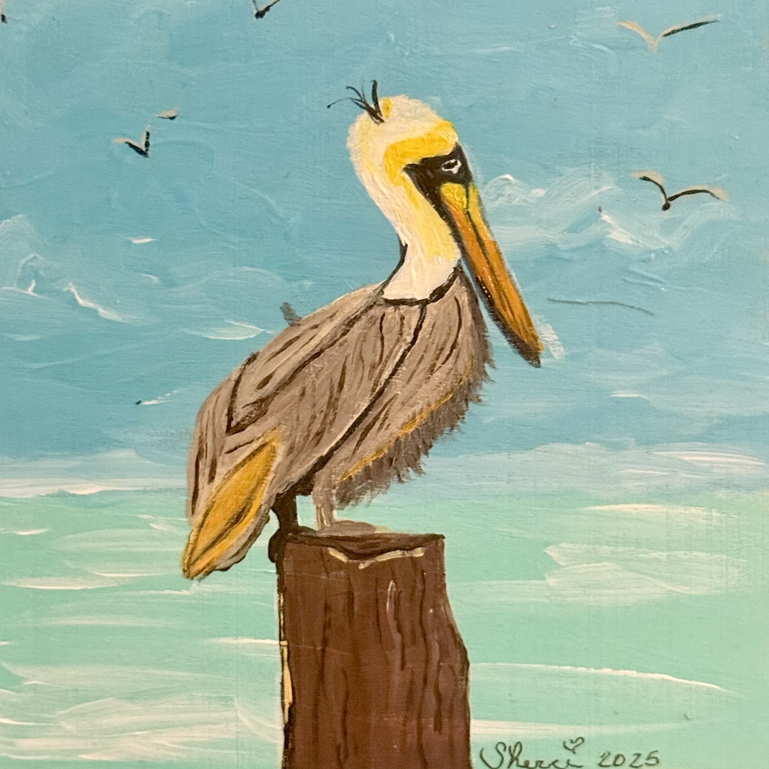 Brown pelican perched on a piling beside the water