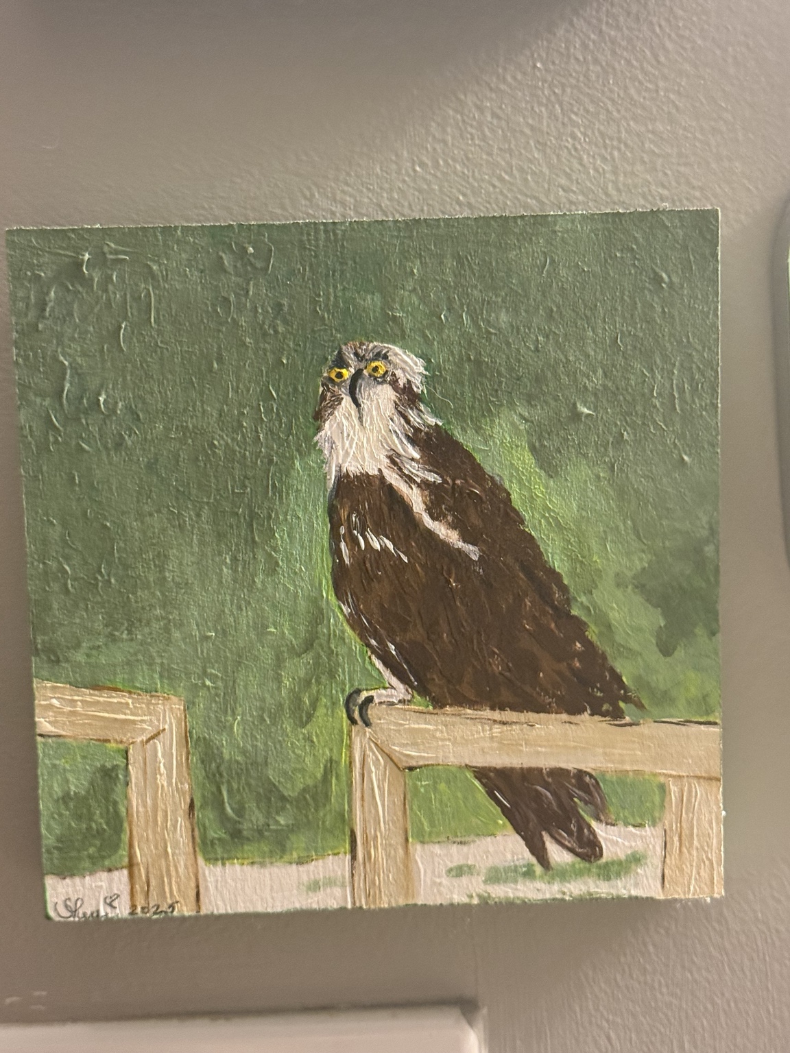 Painting of an osprey perched on a railing