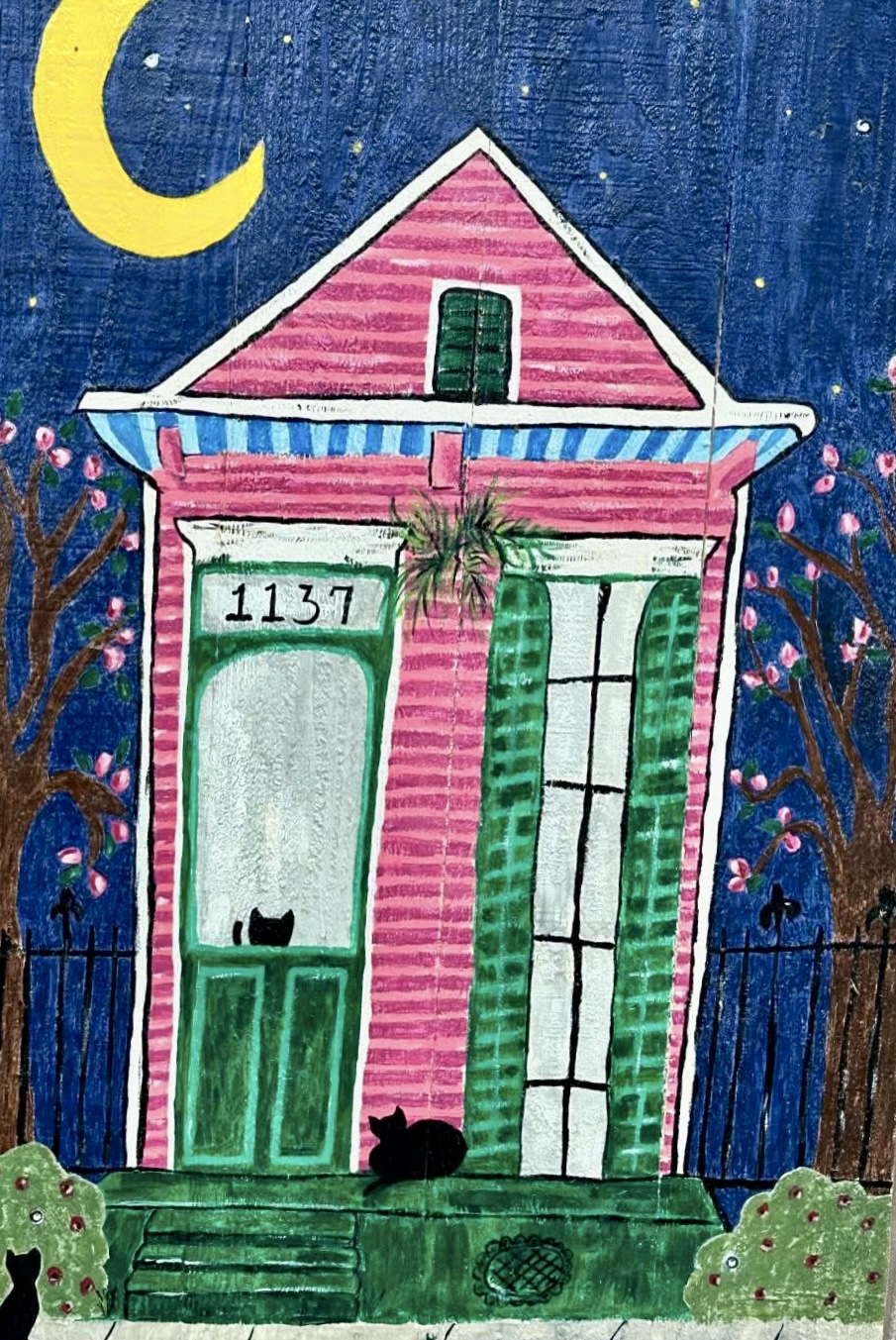 Pink New Orleans house beneath a crescent moon