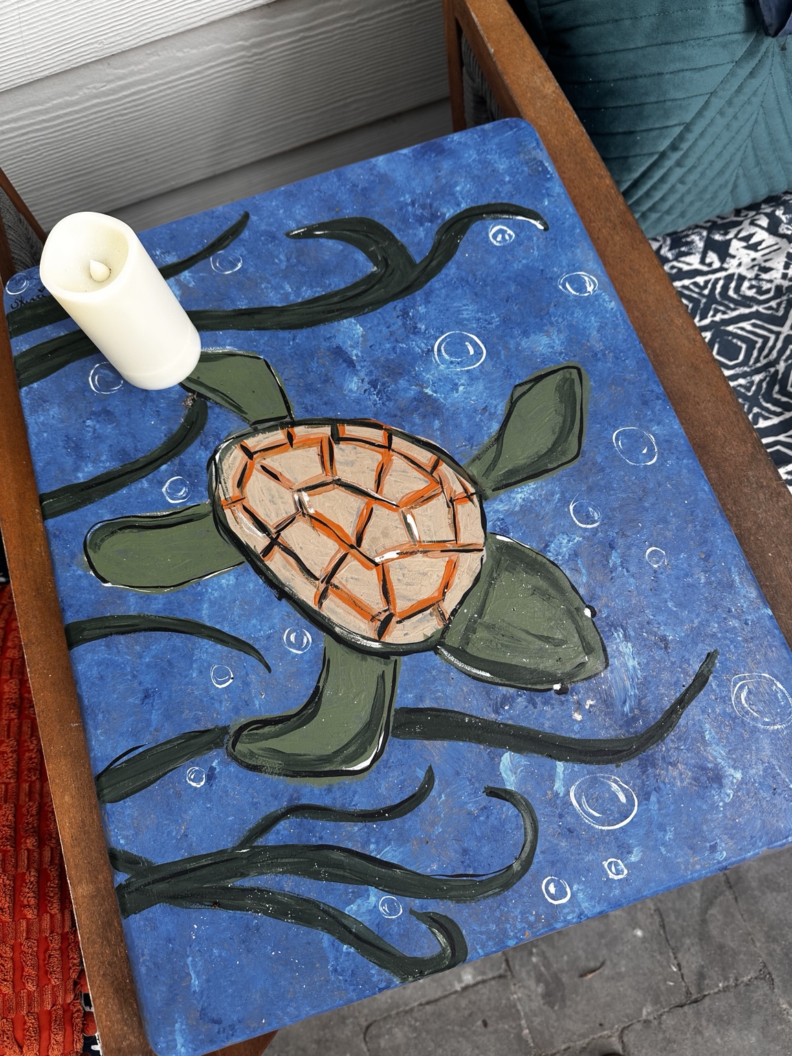 Painted blue tabletop with a swimming sea turtle and bubbles