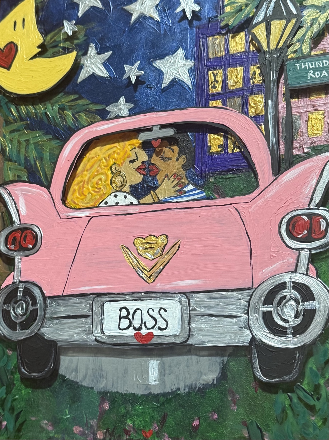 Couple kissing inside a pink Cadillac under a starry night sky