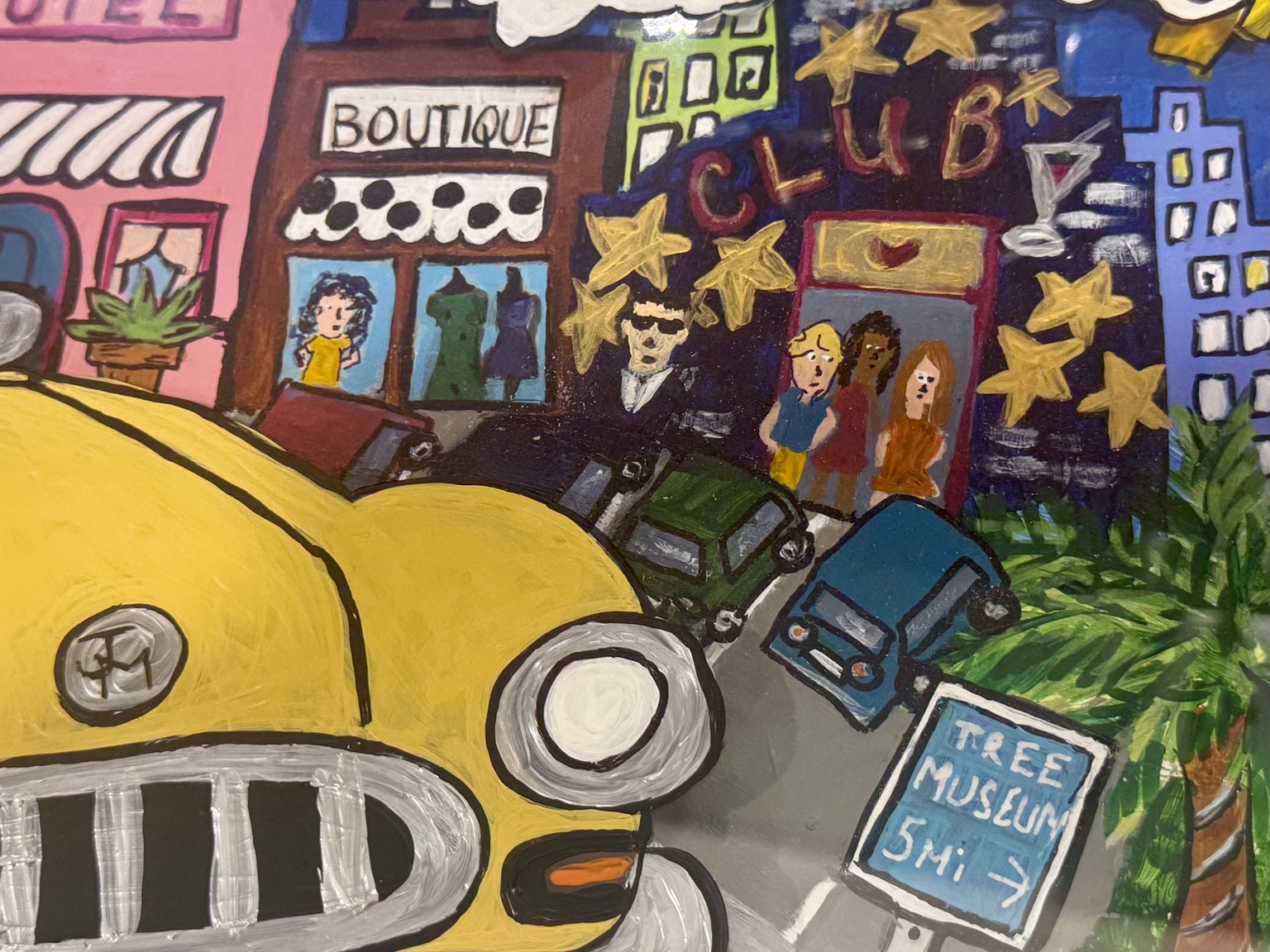 Close-up of the taxi, Pink Hotel, and city buildings