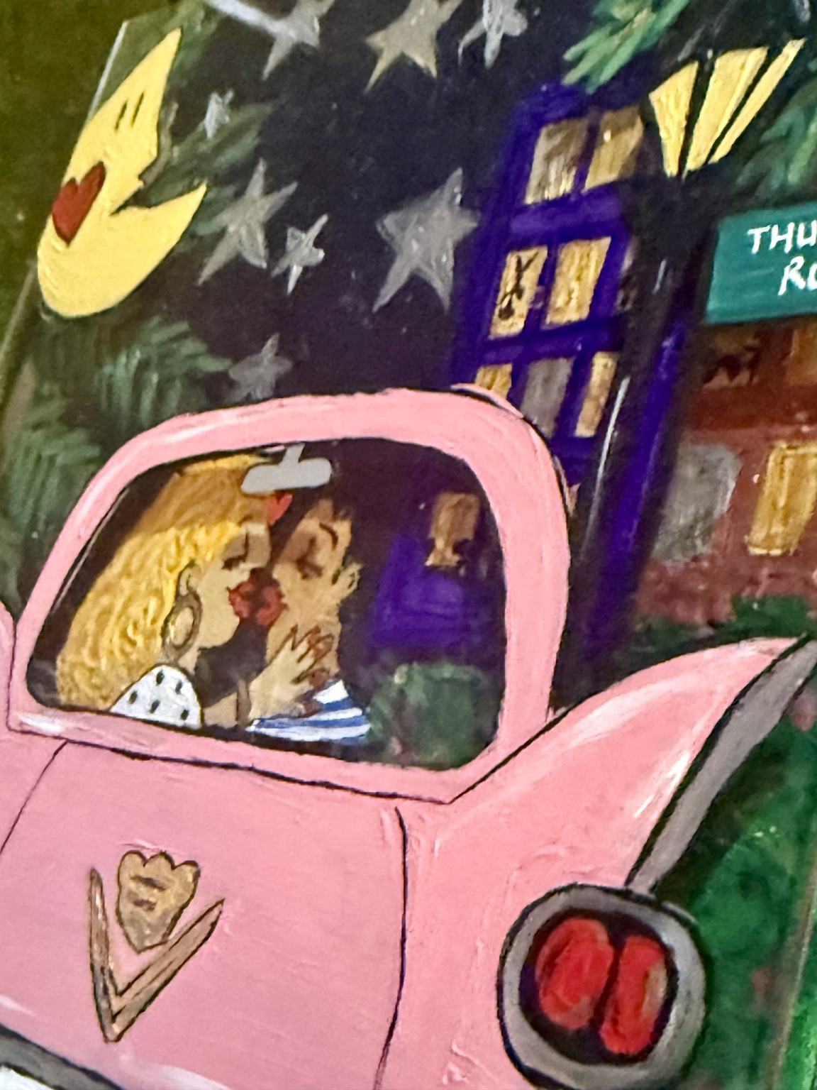 Angled view showing the raised pink car and painted background