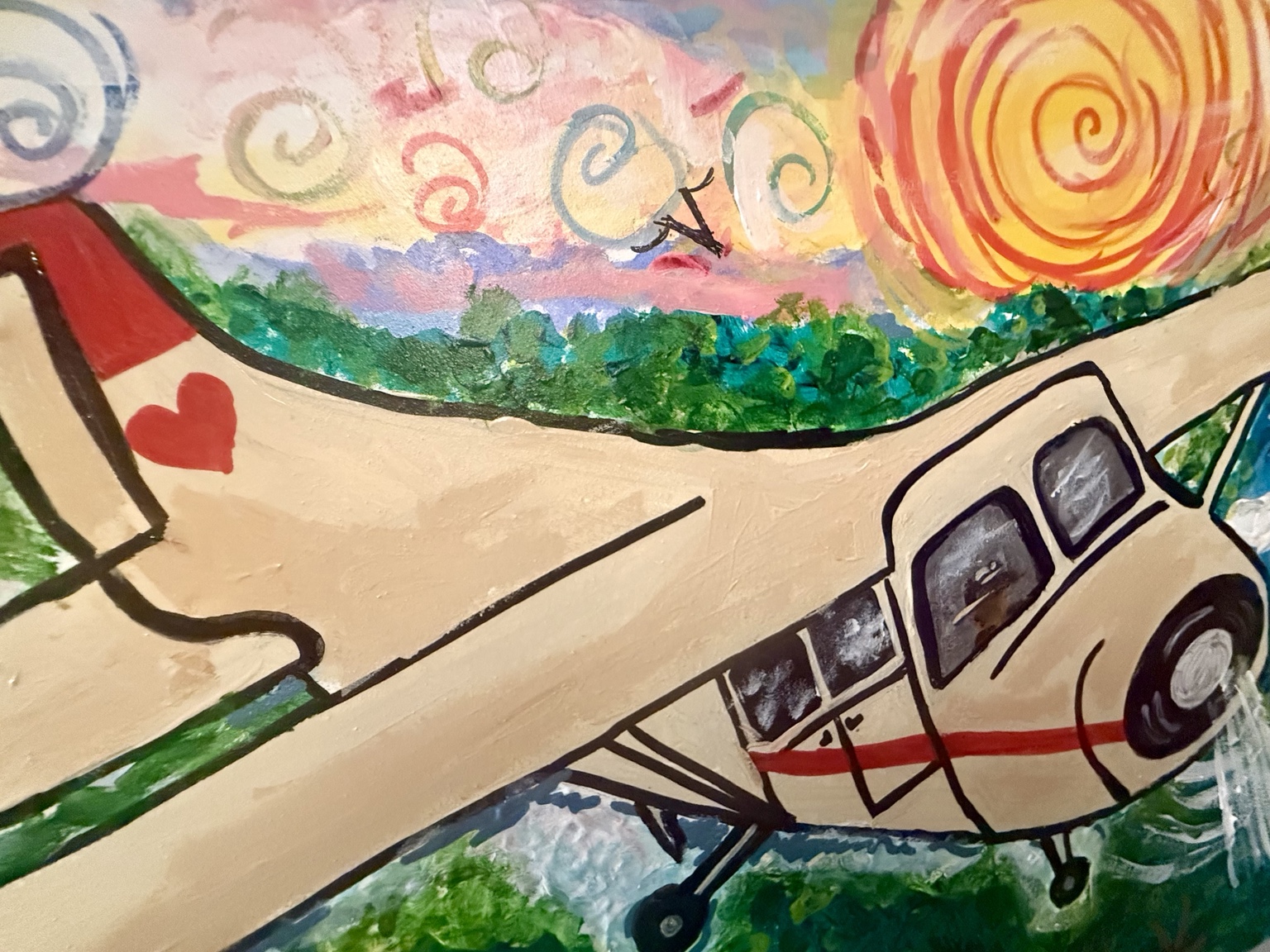 Close-up of the plane's red heart and swirling sunset sky