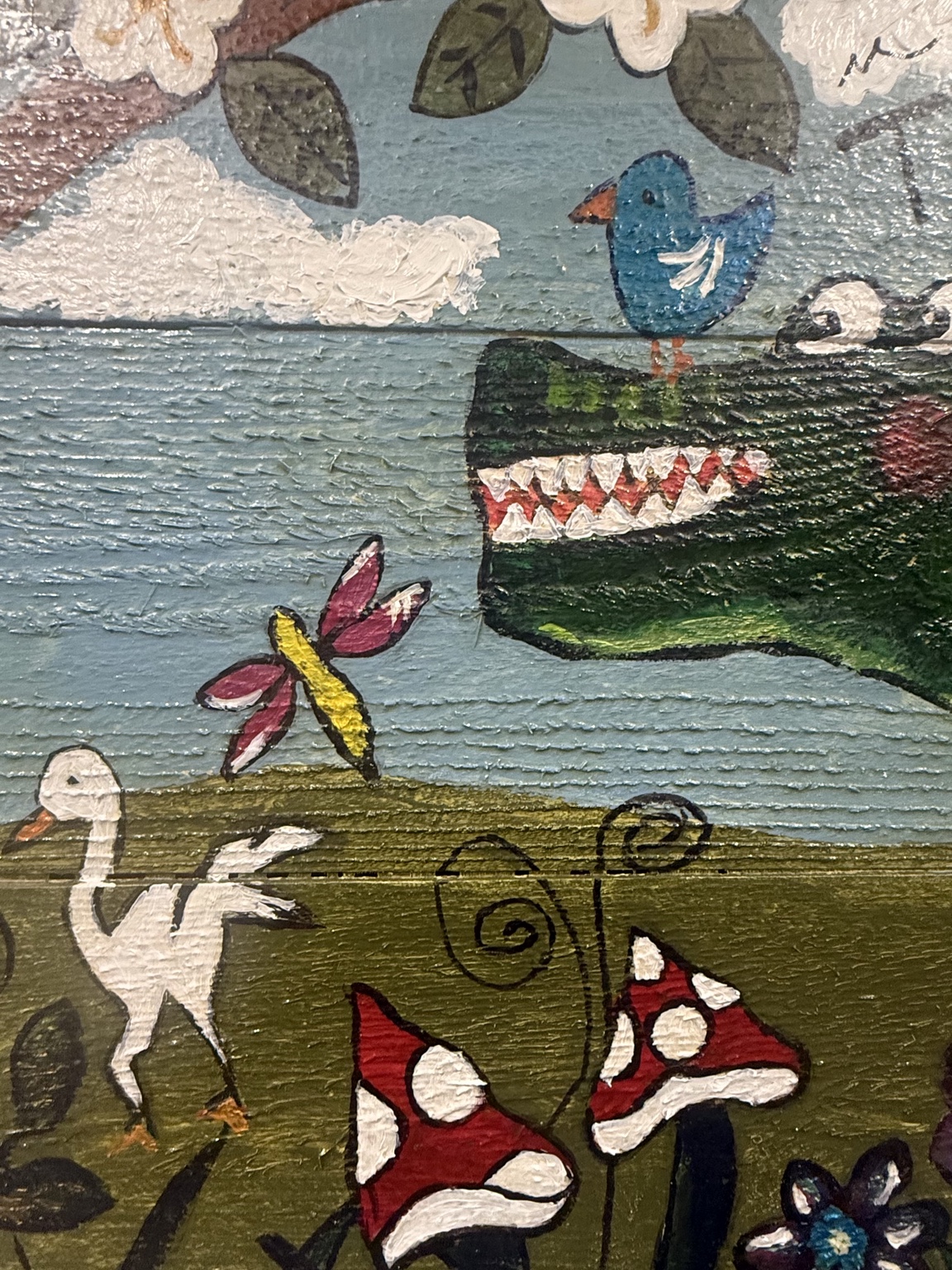 Close-up of the birds, flowers, and painted wood texture